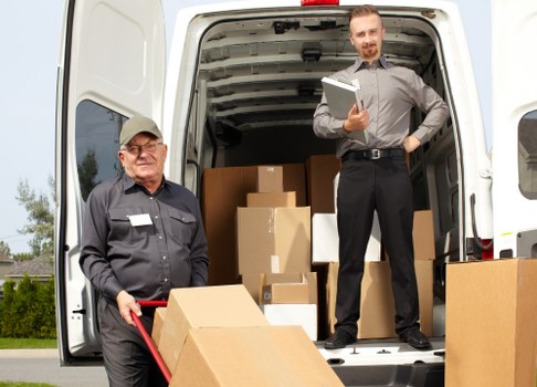 Man with van loading furniture for a move in Kenton