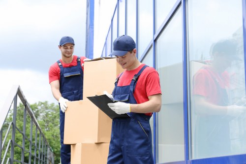 Removal professionals loading office items carefully